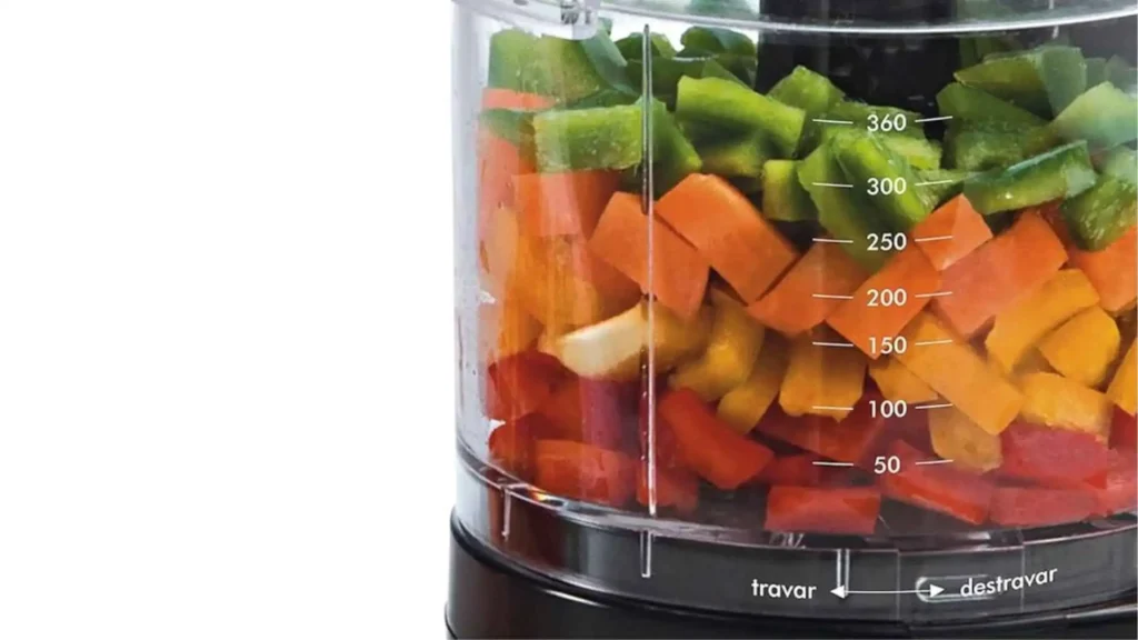 Close da jarra transparente do processador de alimentos Britânia 2P mostrando legumes picados em camadas coloridas