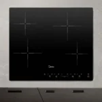 Vista superior de um cooktop 4 bocas Midea CCB40P2 vitrocerâmico embutido em uma bancada de cozinha planejada cinza clara ao lado de ingredientes culinários