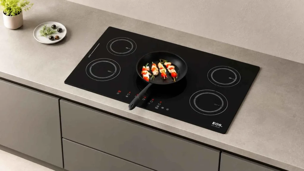 Cooktop de indução EOS ECI05EP de 5 bocas embutido em bancada cinza de cozinha planejada