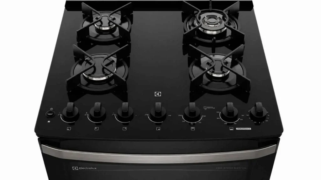 Visão superior da mesa de vidro temperado preta e trempes de ferro fundido do fogão 4 bocas Electrolux Experience FE4DB