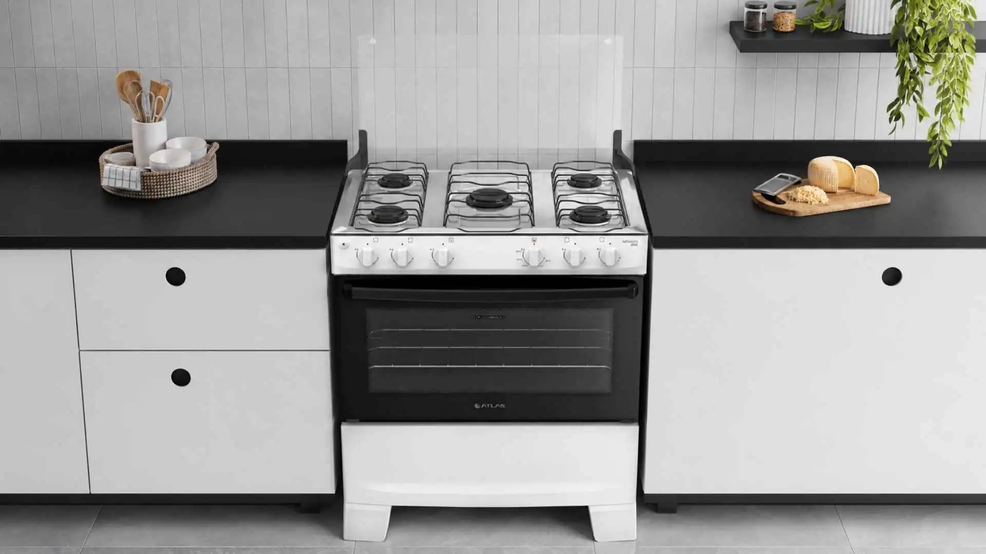 Fogão 5 bocas Atlas Mônaco Plus branco com mesa de inox instalado entre armários de uma cozinha moderna