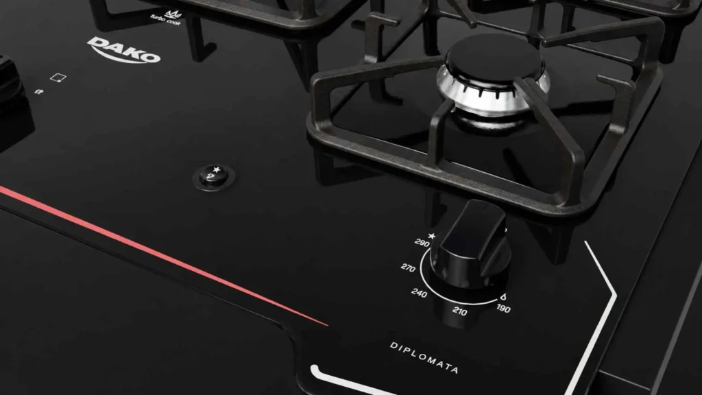 Detalhe aproximado da mesa de vidro temperado preto e dos botões removíveis do fogão de embutir Dako Diplomata 5 bocas