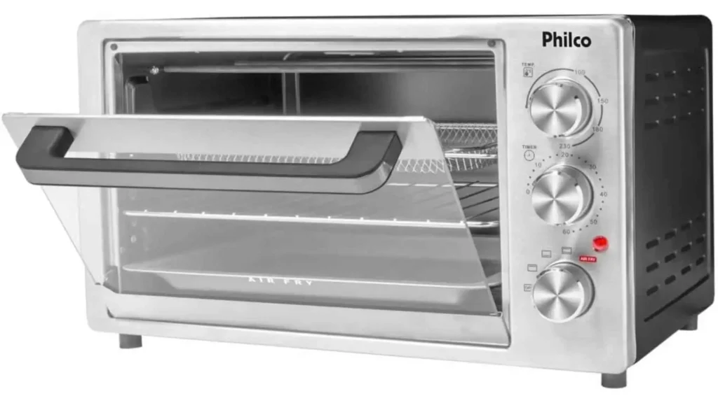 Design externo em inox do Forno Elétrico Philco PFE40I com porta de vidro temperado entreaberta e botões de controle analógico