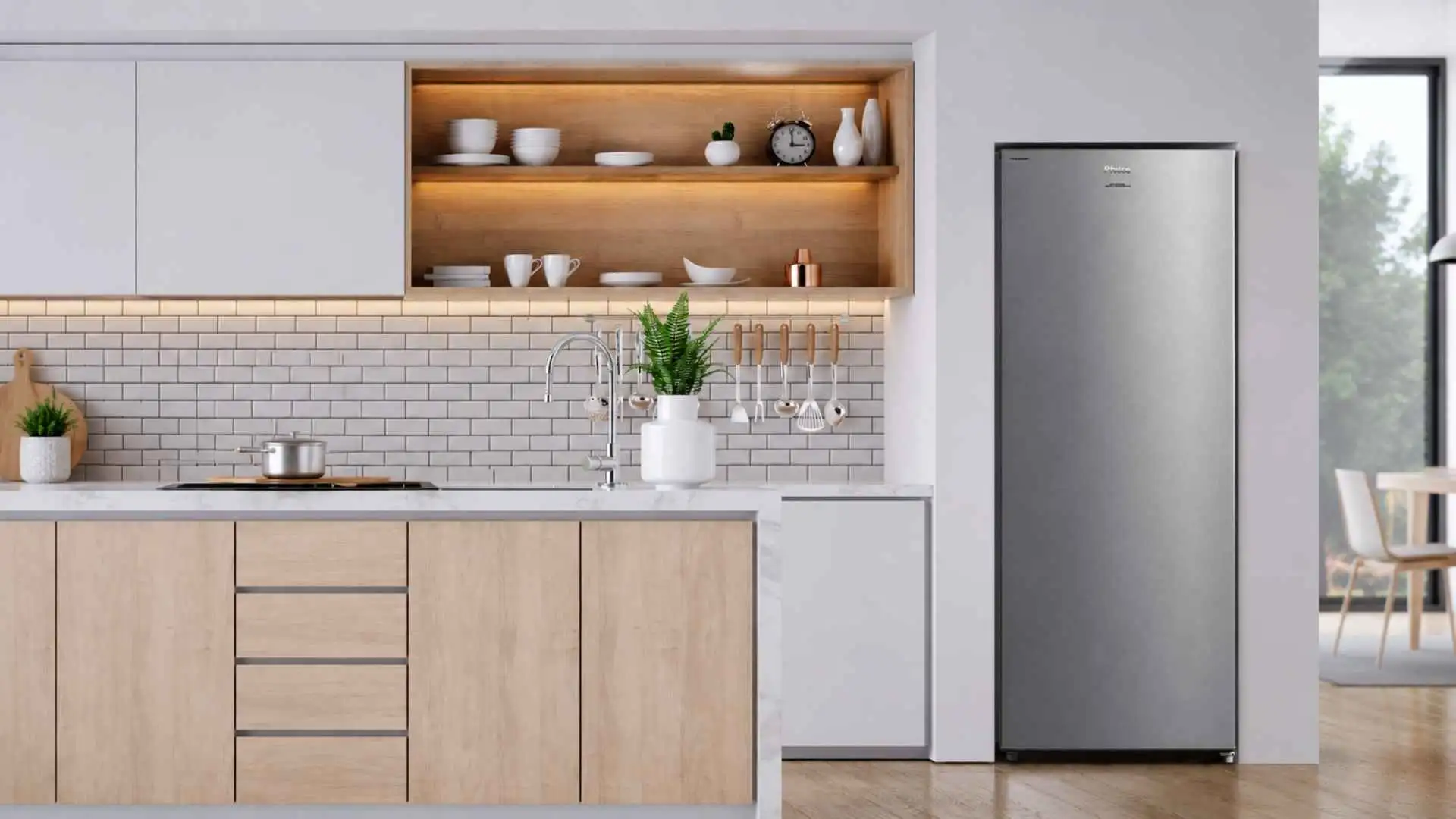 Vista frontal do Freezer Vertical Philco 201L PFV205I com acabamento em aço inox, instalado em um ambiente de cozinha moderna com armários planejados